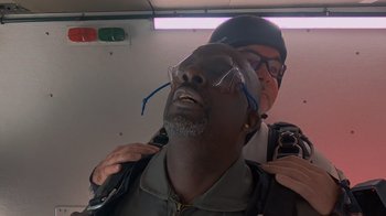 Movie still from “Jackass 4.5” (2022), directed by Jeff Tremaine – A man is being fitted for a face mask; Close Up shot, Overhead angle