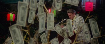 Movie still from “Jaws 2” (1978), directed by Jeannot Szwarc – A man in a suit and tie speaking at a podium; Medium shot, Low angle