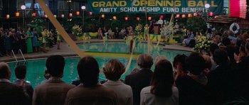 Movie still from “Jaws 2” (1978), directed by Jeannot Szwarc – A group of people standing in front of a swimming pool; Extreme Wide shot, High angle