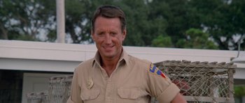 Movie still from “Jaws 2” (1978), directed by Jeannot Szwarc – A person wearing a uniform smiling; Close Up shot, Low angle