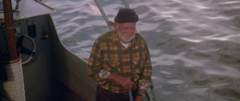 Movie still from “Jaws 2” (1978), directed by Jeannot Szwarc – An older man standing on the deck of a boat; Medium shot, High angle