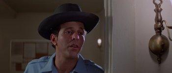 Movie still from “Jaws 2” (1978), directed by Jeannot Szwarc – A man wearing a black hat looking at the camera; Close Up shot, Low angle