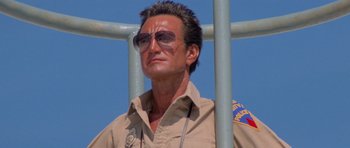 Movie still from “Jaws 2” (1978), directed by Jeannot Szwarc – A person wearing glasses and a uniform; Close Up shot, Low angle