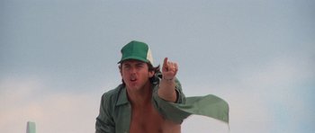 Movie still from “Jaws 2” (1978), directed by Jeannot Szwarc – A man in a green hat is pointing to the sky; Close Up shot, Low angle