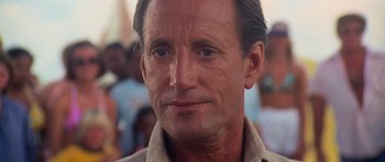 Movie still from “Jaws 2” (1978), directed by Jeannot Szwarc – A person with a crowd in the background; Close Up shot, Over the shoulder angle