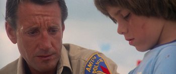 Movie still from “Jaws 2” (1978), directed by Jeannot Szwarc – A man and a boy are looking at each other; Close Up shot, Over the shoulder angle