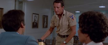 Movie still from “Jaws 2” (1978), directed by Jeannot Szwarc – A man riding a bike in a room; Medium shot, Over the shoulder angle