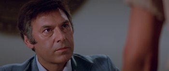 Movie still from “Jaws 2” (1978), directed by Jeannot Szwarc – A person wearing a suit and tie; Close Up shot, Low angle