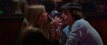 Movie still from “Jaws 2” (1978), directed by Jeannot Szwarc – A man and a woman drinking wine at a bar; Medium shot, Over the shoulder angle