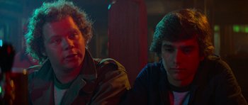 Movie still from “Jaws 2” (1978), directed by Jeannot Szwarc – Two young men sitting next to each other in a dark room; Close Up shot, Over the shoulder angle