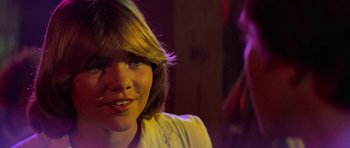 Movie still from “Jaws 2” (1978), directed by Jeannot Szwarc – A young woman with a smile on her face; Close Up shot, Over the shoulder angle