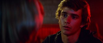 Movie still from “Jaws 2” (1978), directed by Jeannot Szwarc – A young man is looking into the camera; Close Up shot, Over the shoulder angle