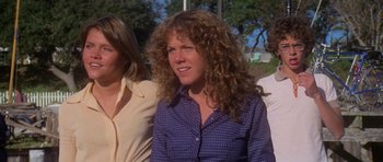 Movie still from “Jaws 2” (1978), directed by Jeannot Szwarc – A woman in a plaid shirt is looking at the camera; Close Up shot, Low angle