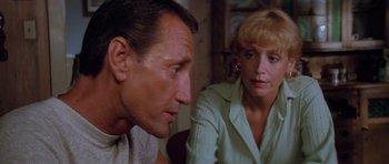 Movie still from “Jaws 2” (1978), directed by Jeannot Szwarc – A man and a woman sitting next to each other in a room; Close Up shot, Low angle