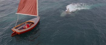 Movie still from “Jaws 2” (1978), directed by Jeannot Szwarc – A boat is in the water with a shark in the background; Extreme Wide shot, High angle