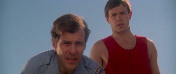 Movie still from “Jaws 2” (1978), directed by Jeannot Szwarc – Two men are standing next to each other; Close Up shot, Low angle