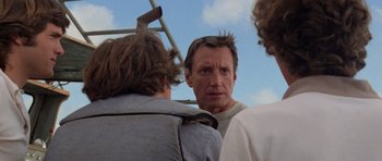 Movie still from “Jaws 2” (1978), directed by Jeannot Szwarc – A group of people standing next to each other on a field; Close Up shot, Low angle