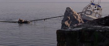 Movie still from “Jaws 2” (1978), directed by Jeannot Szwarc – A fishing pole sitting in the middle of a body of water; Extreme Wide shot, High angle