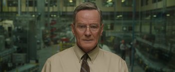 Movie still from “Jerry and Marge Go Large” (2022), directed by David Frankel – An older man wearing a tan shirt and a brown neck tie; Close Up shot, Low angle