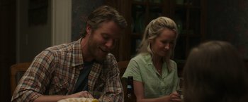 Movie still from “Jerry and Marge Go Large” (2022), directed by David Frankel – A man and a woman sitting at a dinner table; Medium shot, Over the shoulder angle