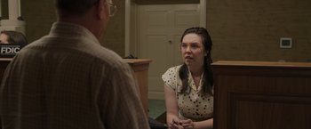 Movie still from “Jerry and Marge Go Large” (2022), directed by David Frankel – A woman in polka dot shirt talking to a man in glasses; Medium shot, Over the shoulder angle