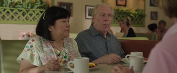 Movie still from “Jerry and Marge Go Large” (2022), directed by David Frankel – An older man and woman sitting at a dining table; Close Up shot, Over the shoulder angle