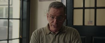 Movie still from “Jerry and Marge Go Large” (2022), directed by David Frankel – An older man wearing glasses and a tan shirt; Close Up shot, Over the shoulder angle