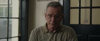 Movie still from “Jerry and Marge Go Large” (2022), directed by David Frankel – An older man wearing glasses and a tan shirt; Close Up shot, Over the shoulder angle