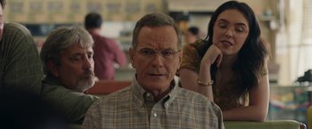 Movie still from “Jerry and Marge Go Large” (2022), directed by David Frankel – An older man wearing glasses and a plaid shirt; Close Up shot, Over the shoulder angle