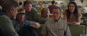 Movie still from “Jerry and Marge Go Large” (2022), directed by David Frankel – A group of men sitting at a table in front of each other; Medium shot, Over the shoulder angle