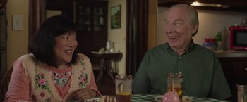 Movie still from “Jerry and Marge Go Large” (2022), directed by David Frankel – A man and a woman sitting at a dinner table; Medium shot, Over the shoulder angle