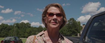 Movie still from “Jerry and Marge Go Large” (2022), directed by David Frankel – A person wearing sunglasses; Close Up shot, Low angle