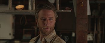 Movie still from “Jerry and Marge Go Large” (2022), directed by David Frankel – A person wearing a plaid shirt; Close Up shot, Over the shoulder angle