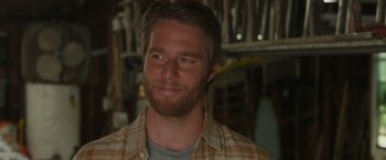 Movie still from “Jerry and Marge Go Large” (2022), directed by David Frankel – A person wearing a plaid shirt; Close Up shot, Over the shoulder angle