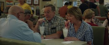 Movie still from “Jerry and Marge Go Large” (2022), directed by David Frankel – A man and a woman sitting at a table drinking milk shakes; Medium shot, Over the shoulder angle