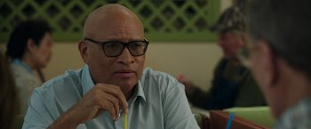 Movie still from “Jerry and Marge Go Large” (2022), directed by David Frankel – An older man with glasses is sitting at a table; Close Up shot, Over the shoulder angle