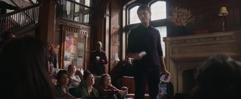 Movie still from “Jerry and Marge Go Large” (2022), directed by David Frankel – A group of people sitting in a room; Medium shot, Over the shoulder angle