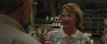 Movie still from “Jerry and Marge Go Large” (2022), directed by David Frankel – A woman holding a glass of wine in her hand; Close Up shot, Over the shoulder angle