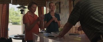 Movie still from “Jerry and Marge Go Large” (2022), directed by David Frankel – Two women standing in front of a table holding nintendo wii game controllers; Medium shot, Low angle