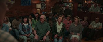 Movie still from “Jerry and Marge Go Large” (2022), directed by David Frankel – A group of people sitting in a living room; Wide shot, High angle
