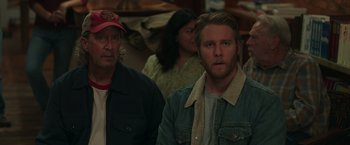 Movie still from “Jerry and Marge Go Large” (2022), directed by David Frankel – A man and a woman standing next to each other in a room; Close Up shot, Over the shoulder angle