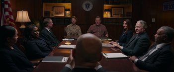 Movie still from “Jerry and Marge Go Large” (2022), directed by David Frankel – A group of people sitting around a table; Medium shot, Over the shoulder angle