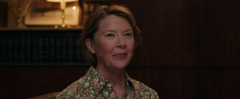 Movie still from “Jerry and Marge Go Large” (2022), directed by David Frankel – An older woman wearing a floral shirt and smiling for the camera; Close Up shot, Low angle