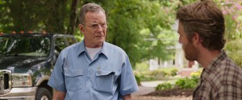 Movie still from “Jerry and Marge Go Large” (2022), directed by David Frankel – An older man wearing glasses and a blue shirt; Close Up shot, Over the shoulder angle