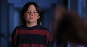 Movie still from “Jerry Maguire” (1996), directed by Cameron Crowe – A boy in a striped shirt is looking at the camera; Close Up shot, Low angle