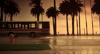 Movie still from “Jerry Maguire” (1996), directed by Cameron Crowe – A bus driving down a street next to palm trees; Extreme Wide shot, Low angle