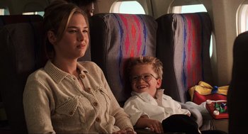 Movie still from “Jerry Maguire” (1996), directed by Cameron Crowe – A woman and a boy sitting on a plane; Medium shot, Over the shoulder angle