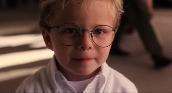 Movie still from “Jerry Maguire” (1996), directed by Cameron Crowe – A little boy wearing glasses and a white shirt; Close Up shot, High angle