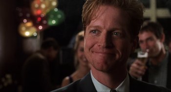 Movie still from “Jerry Maguire” (1996), directed by Cameron Crowe – A person wearing a suit and tie; Close Up shot, Over the shoulder angle