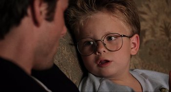 Movie still from “Jerry Maguire” (1996), directed by Cameron Crowe – A little boy wearing glasses looking at a man; Close Up shot, Over the shoulder angle